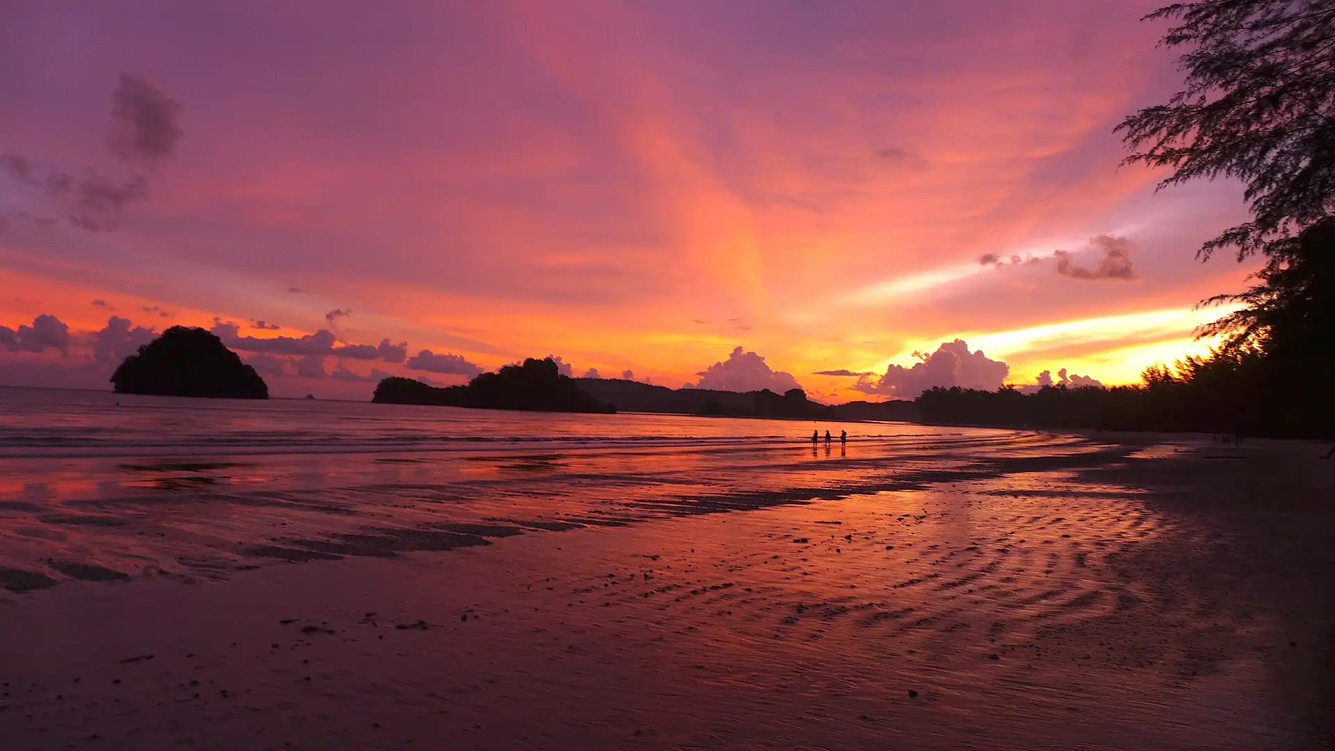Sunset at Ao Nang, Thailand, with limestone islands offshore.